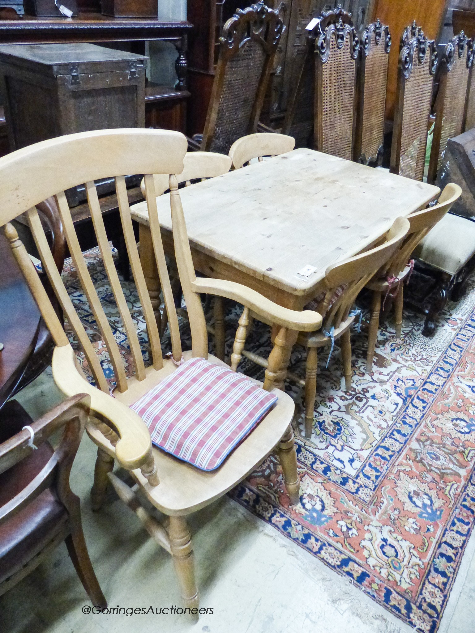 A small Victorian style rectangular pine kitchen table, width 120cm, depth 76cm, height 77cm together with a Windsor beech armchair and two kitchen chairs
